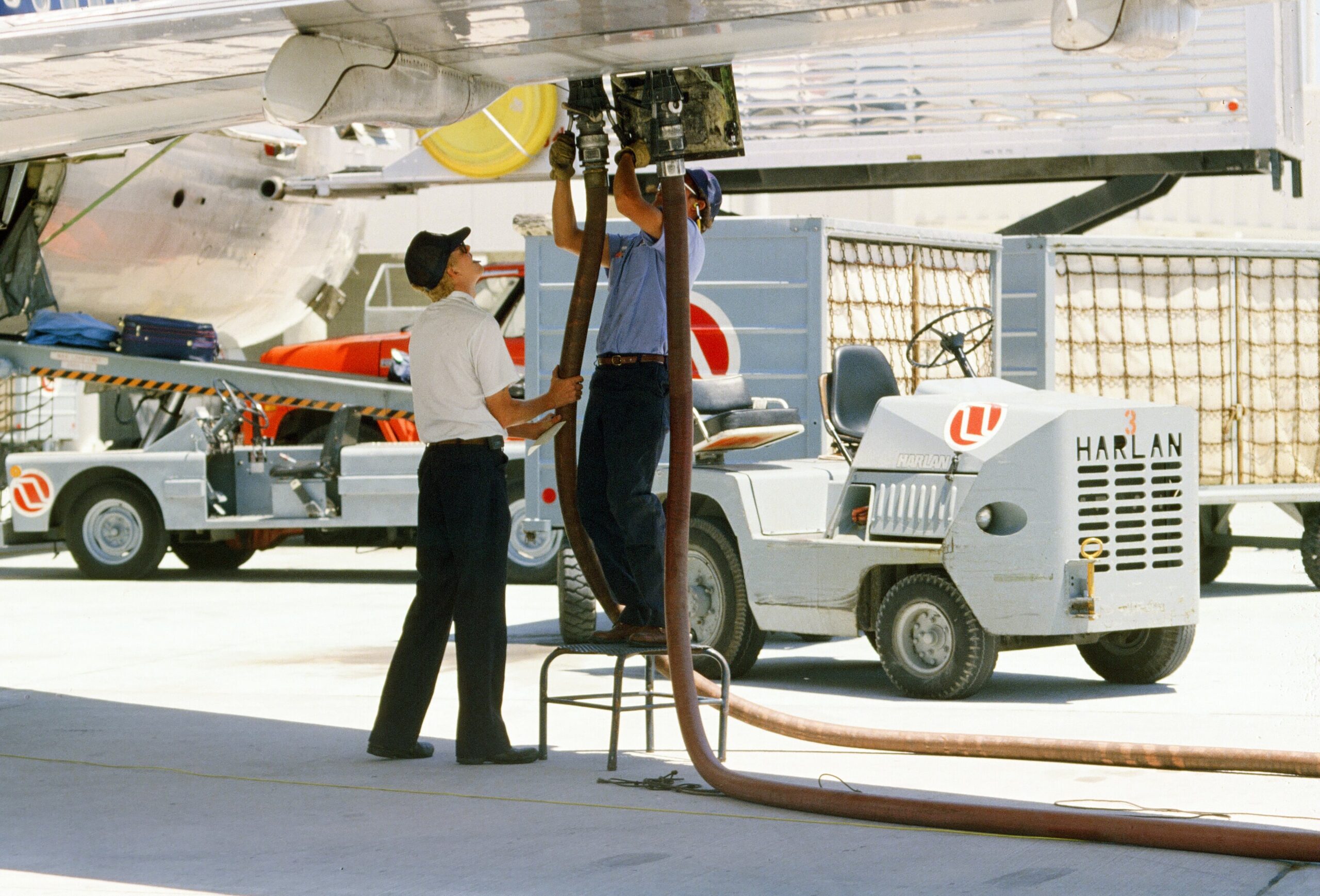 Worker pumping plane fuel